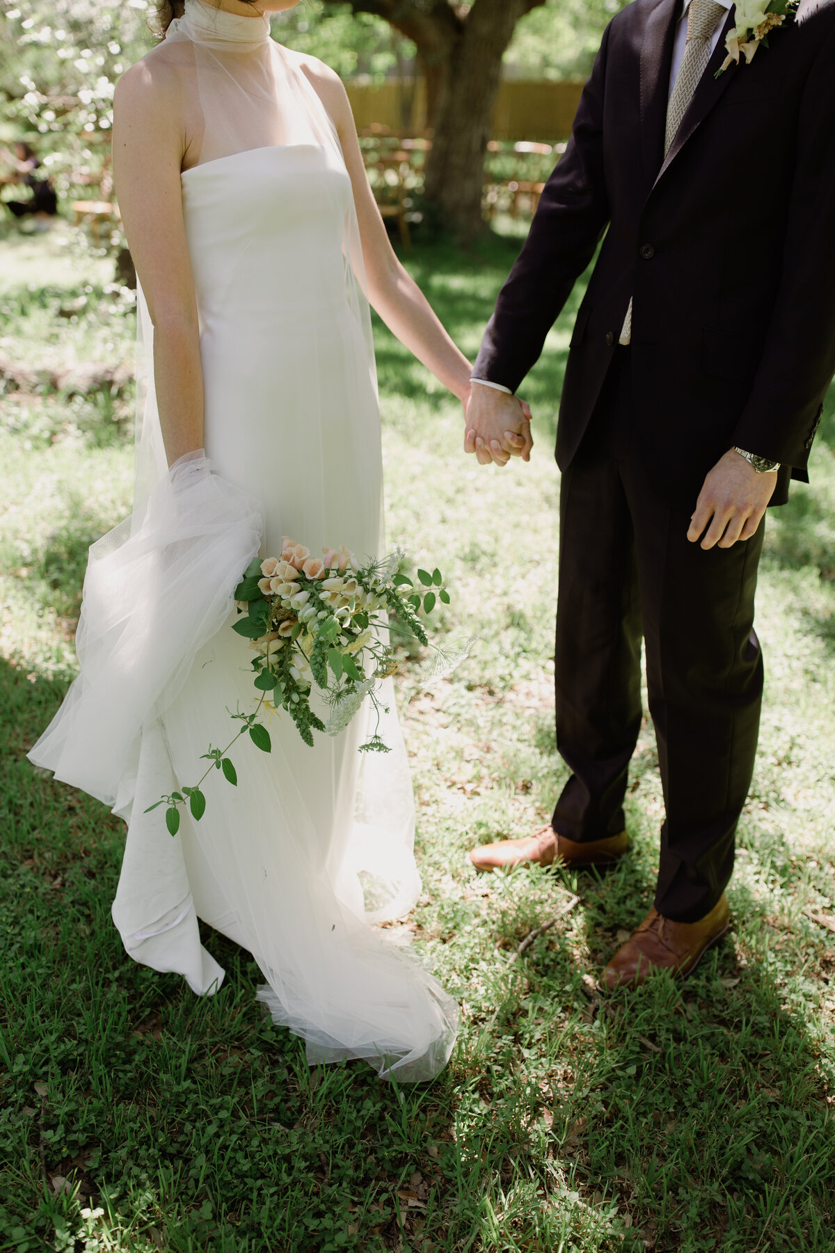 Lower shot of bride and groom holding hands at Mattie's  Austin Wedding