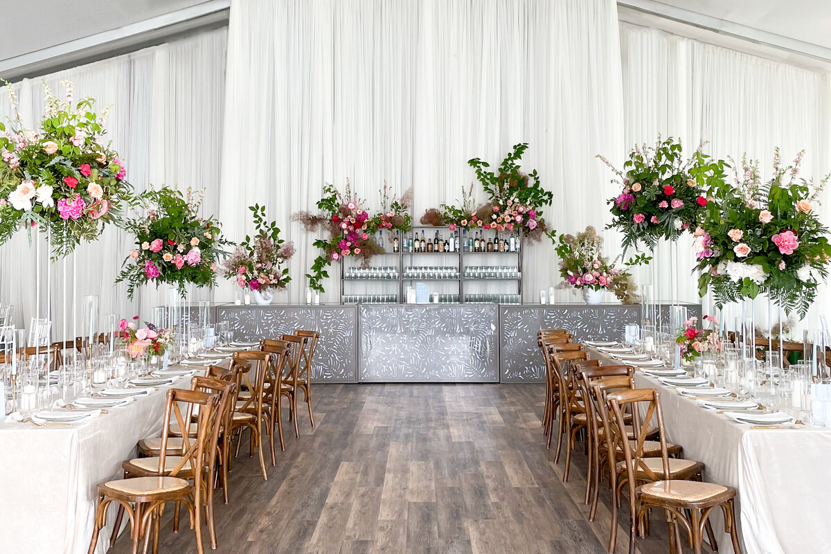 A wedding reception at the Royalmount decorated with bright floral centrepieces and an elaborate bar arrangement.