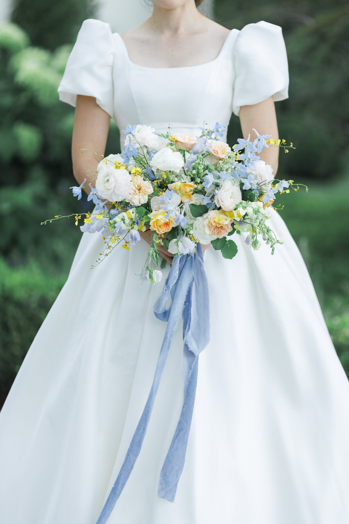 Organic bridal bouquet with pastels, yellow blush and blue, with a blue hand dyed ribbon by Mille Fleur Design.