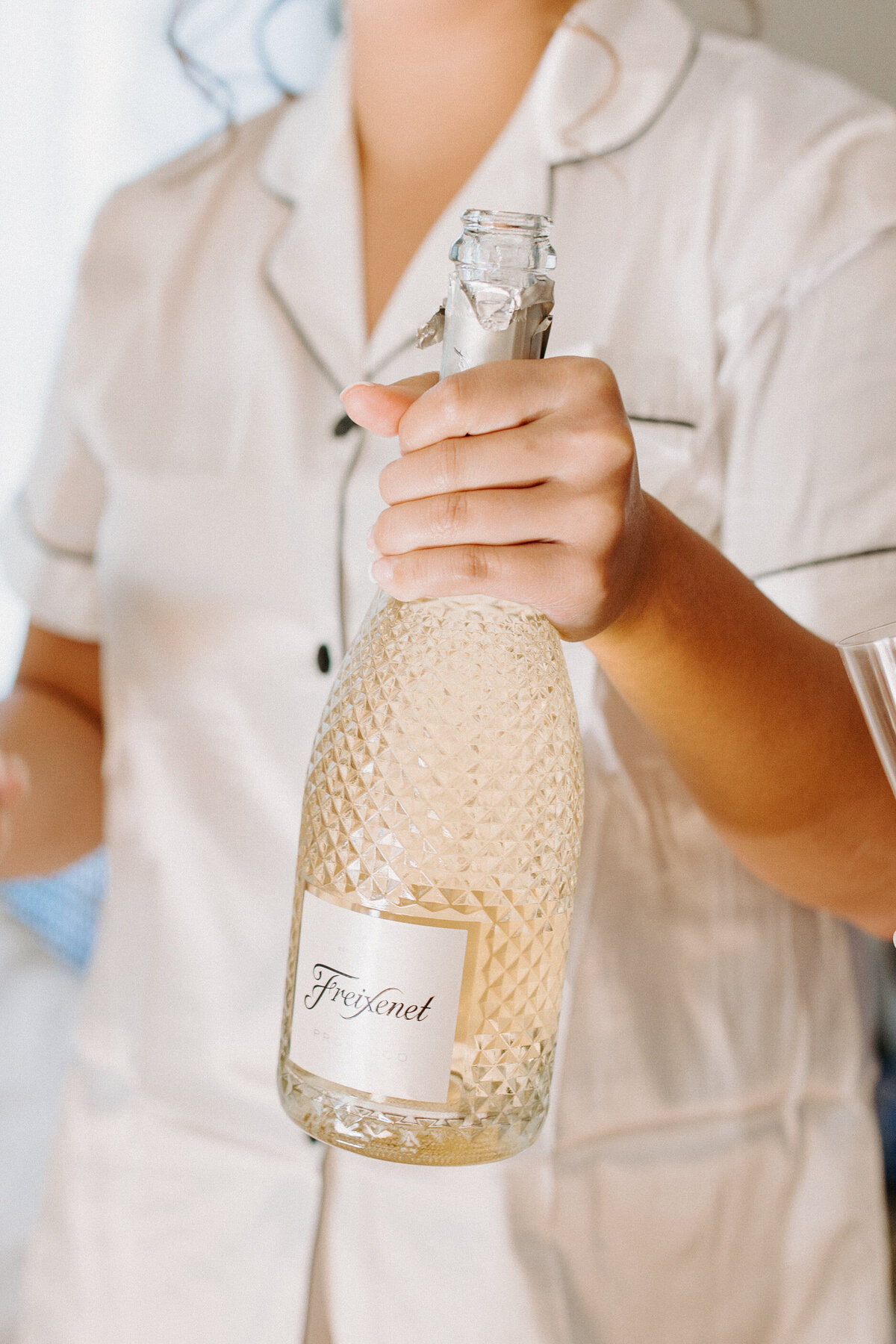 woman holding a crystal champagne bottle
