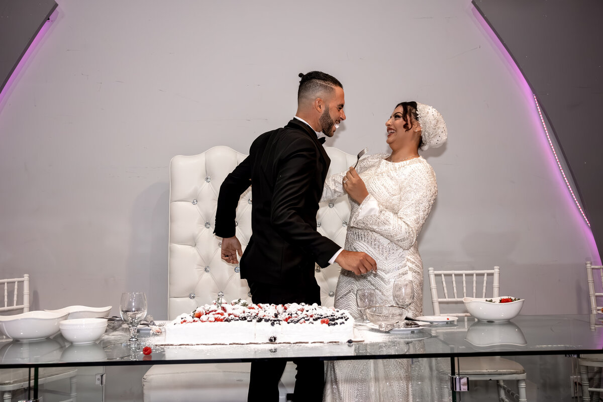 Fun Arabic Wedding Cake Moment in Los Angeles – Bride & Groom Laughing During Cake Cutting