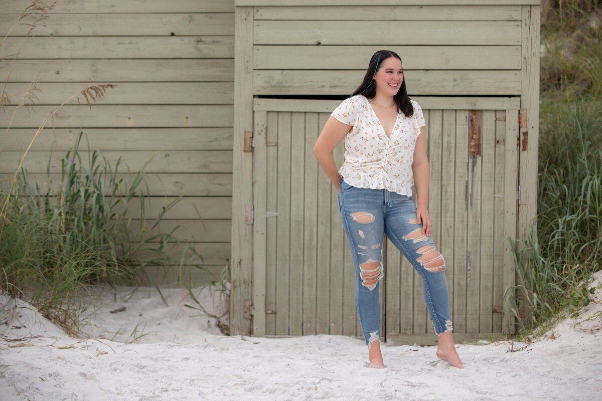 A girl standing in the sand