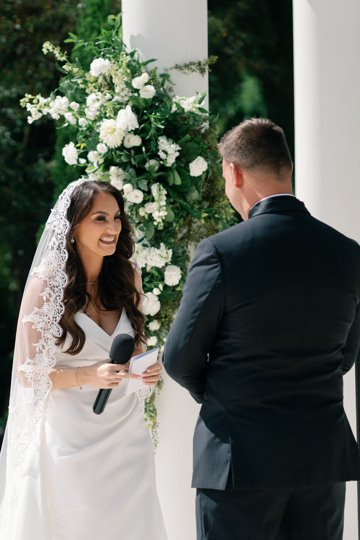 bride reading her vows to groom during ceremony at La Casa Toscana