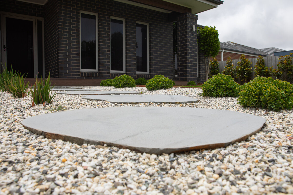 Paving steppers surrounded by greenery and rock work by total landscape & design Warrnambool