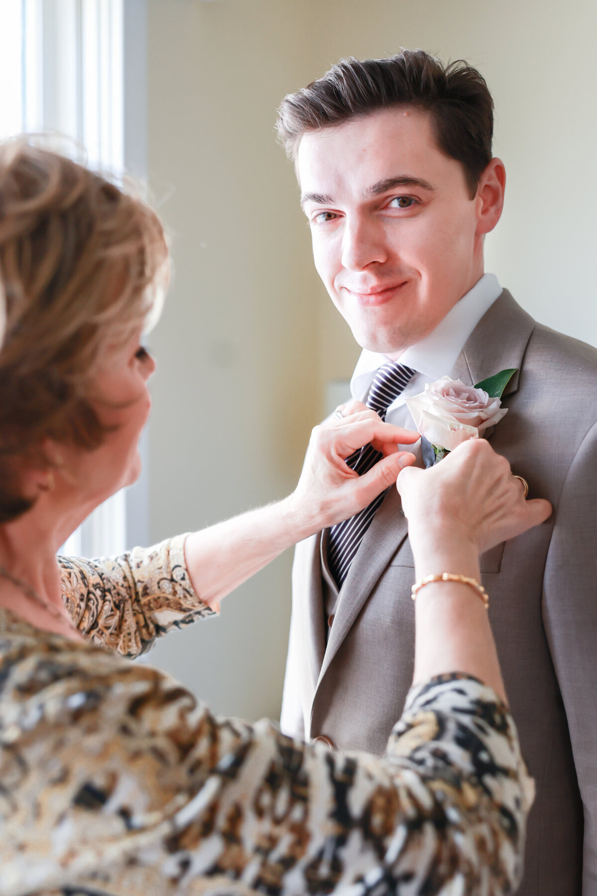 mother-helping-groom-put-on-tie