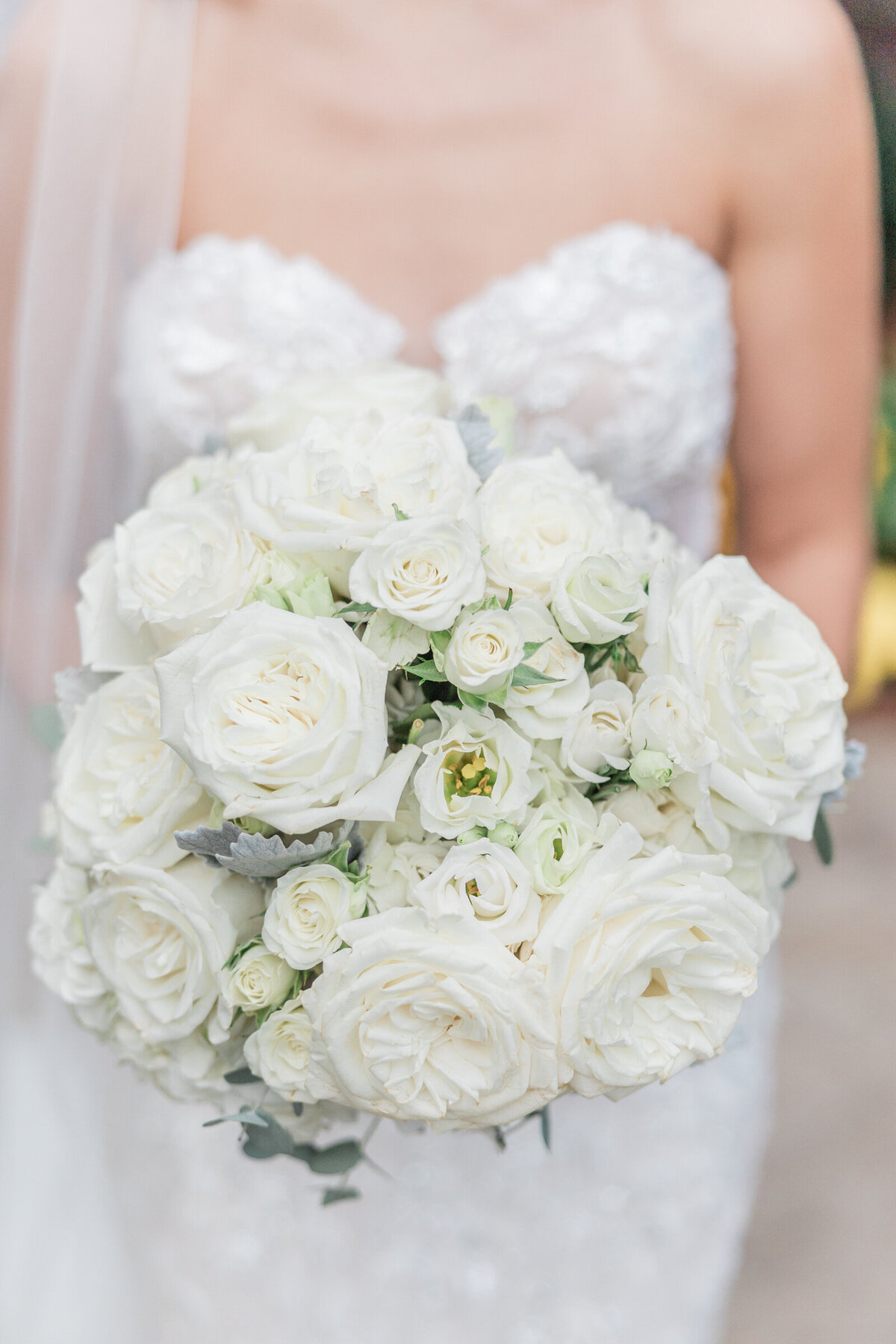 A close up an all white wedding bouquet