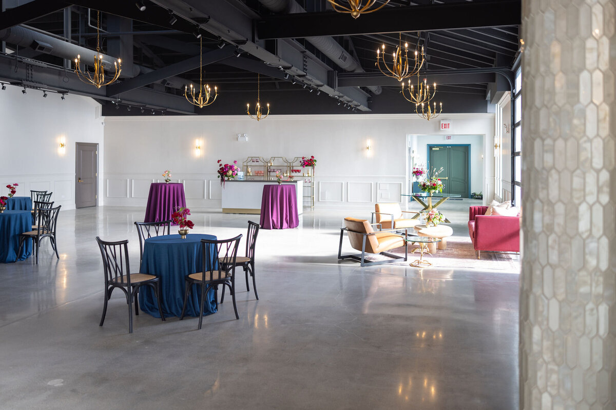 Happy Hour space with in-house cocktail tables, in house bar and lounge vignette, large blank slate space with natural lighting and purposeful detail throughout