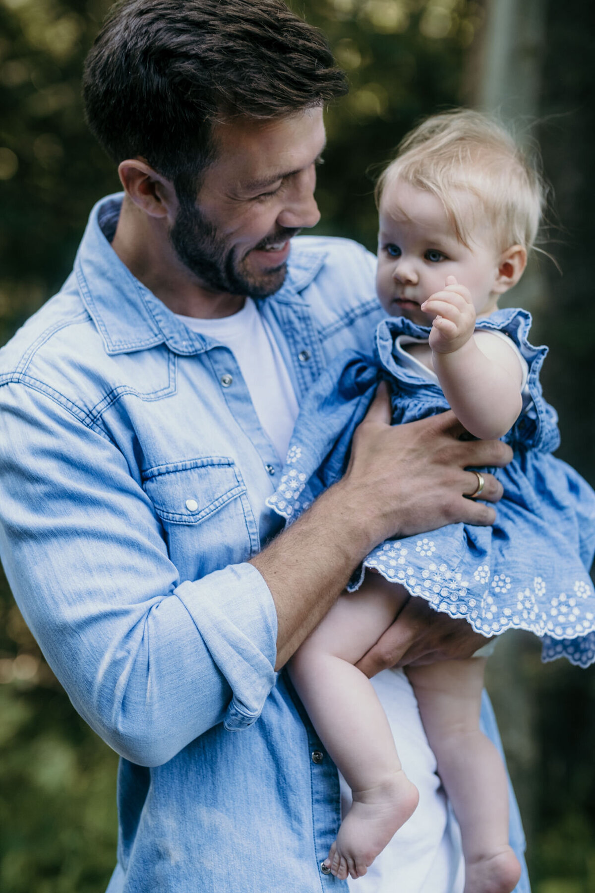 Family session where dad holds babygirl.