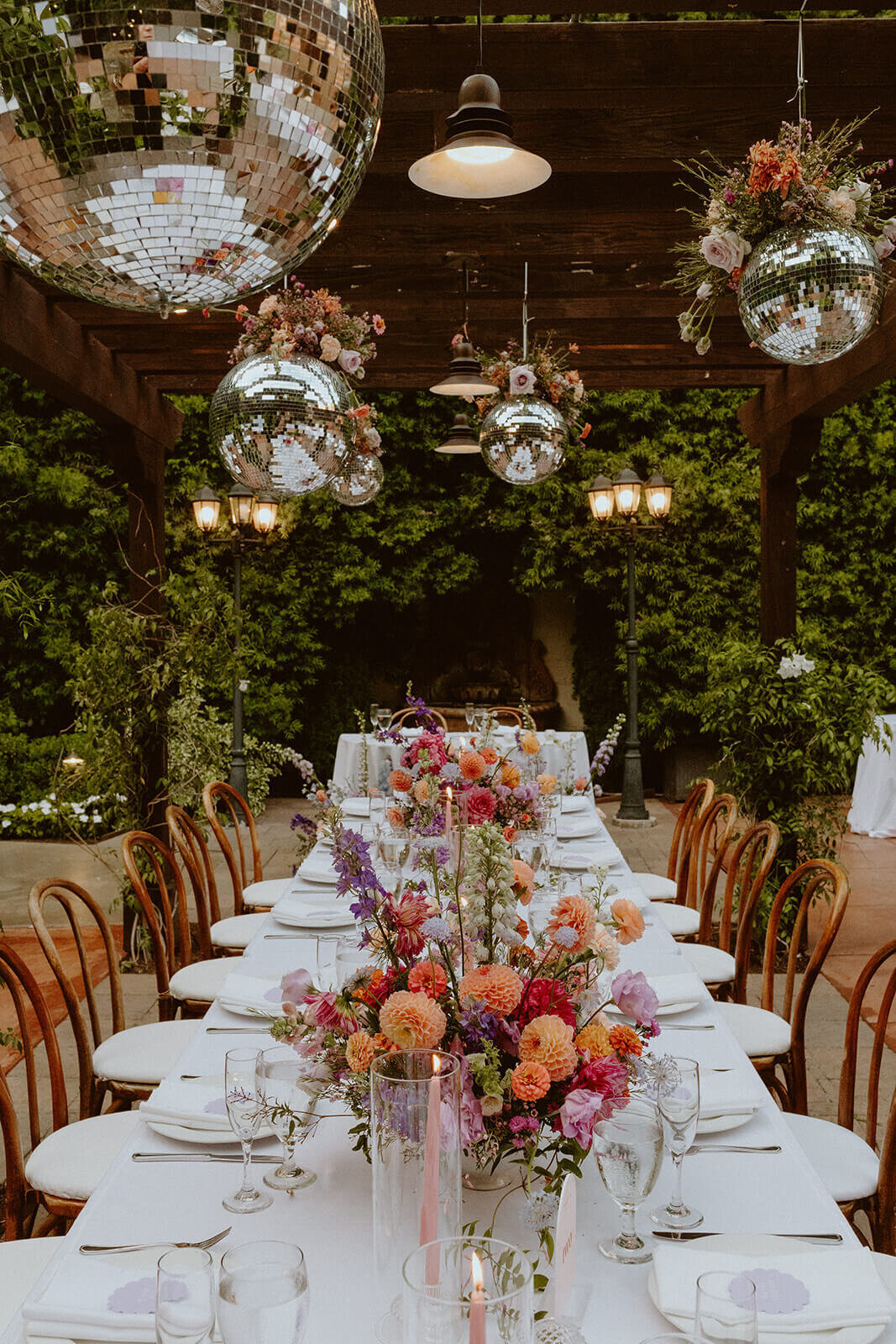 Hanging disco balls  over a table with colorful centerpieces