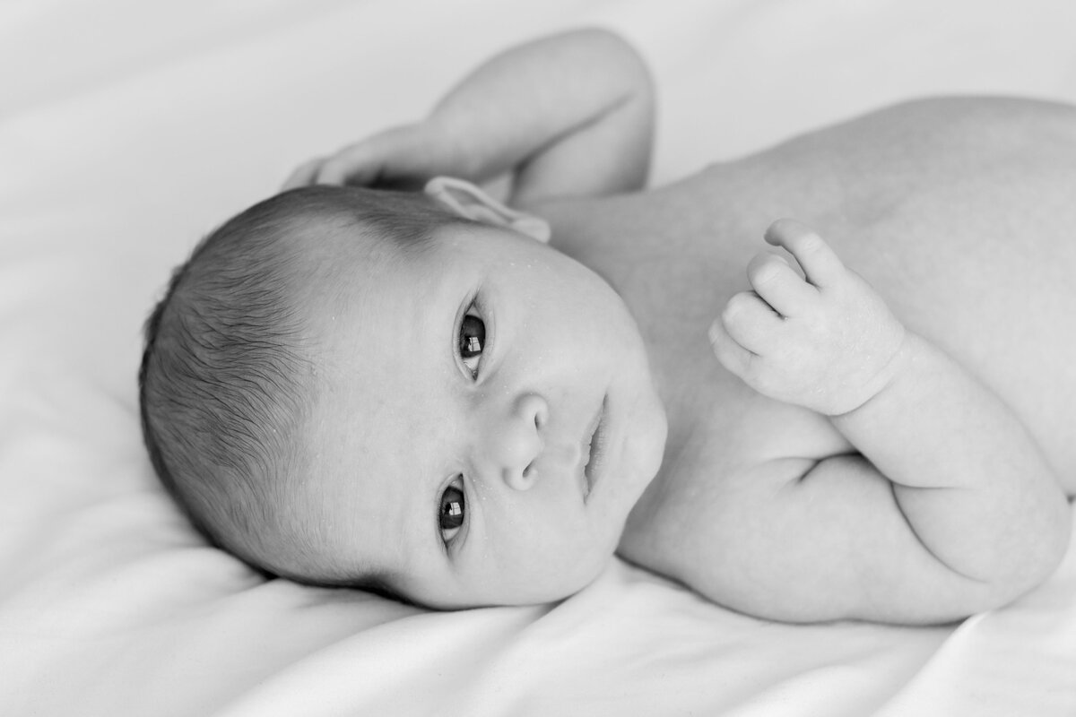 Cozy in home newborn photo of a mother kissing her newborn baby boy