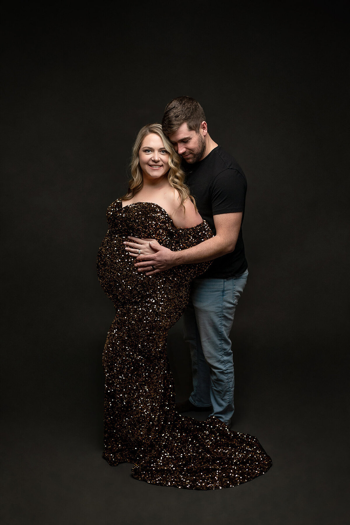 A couple poses during their maternity session.