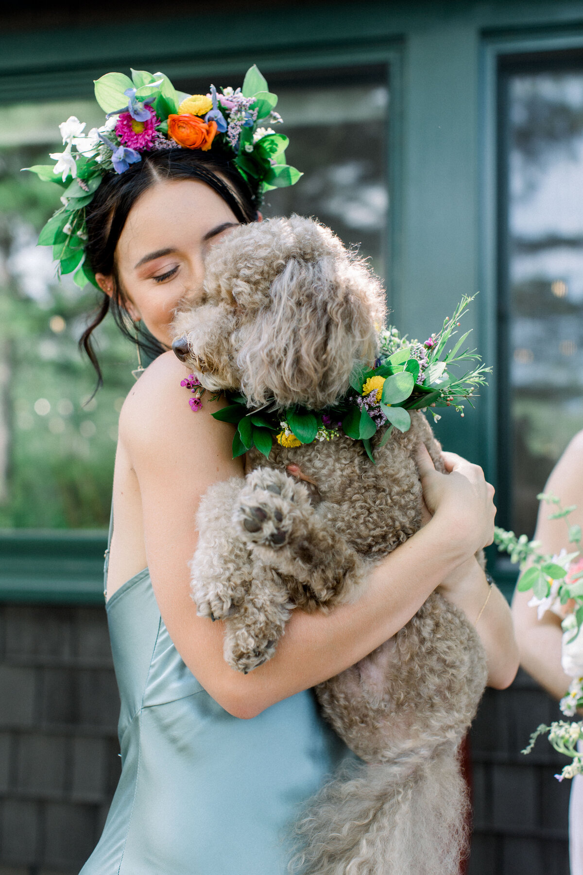 Bridesmaid holding fluffy dog