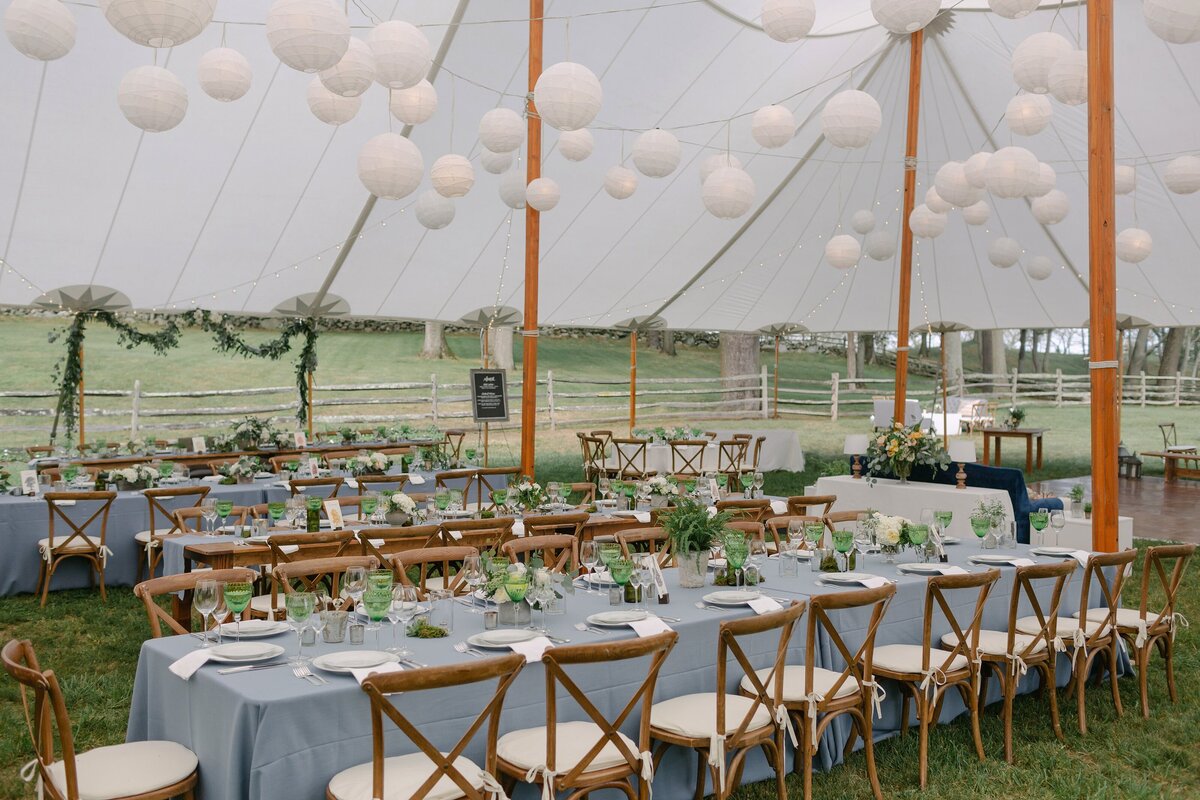 Tented wedding reception with long tables.