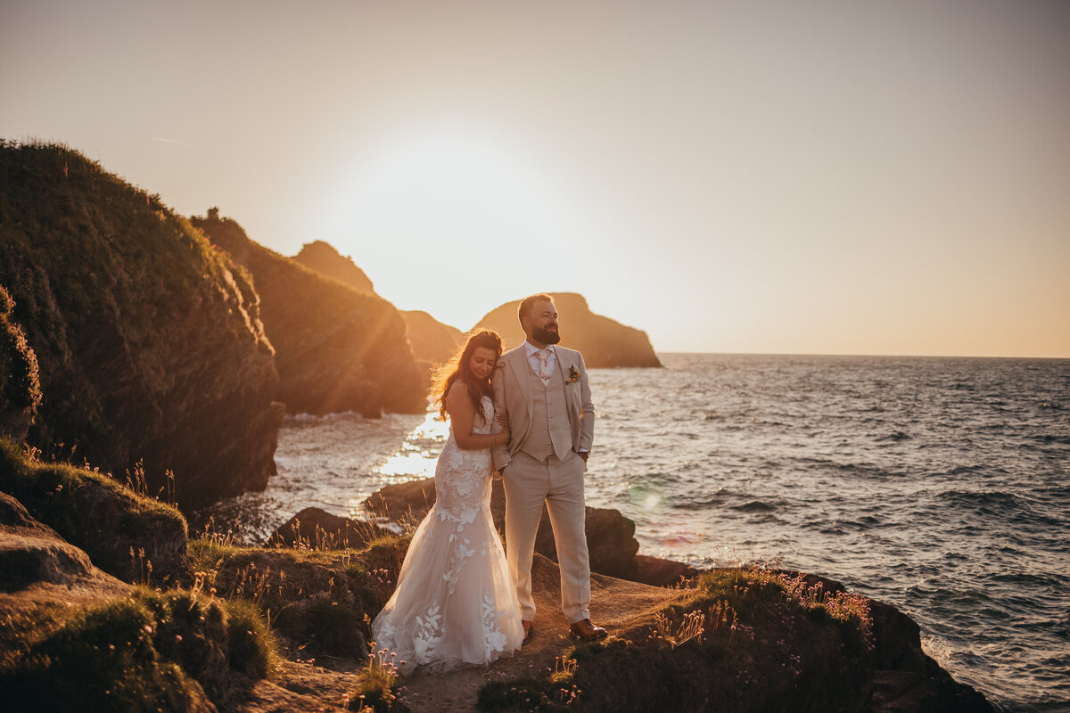 couple pose by the ocean