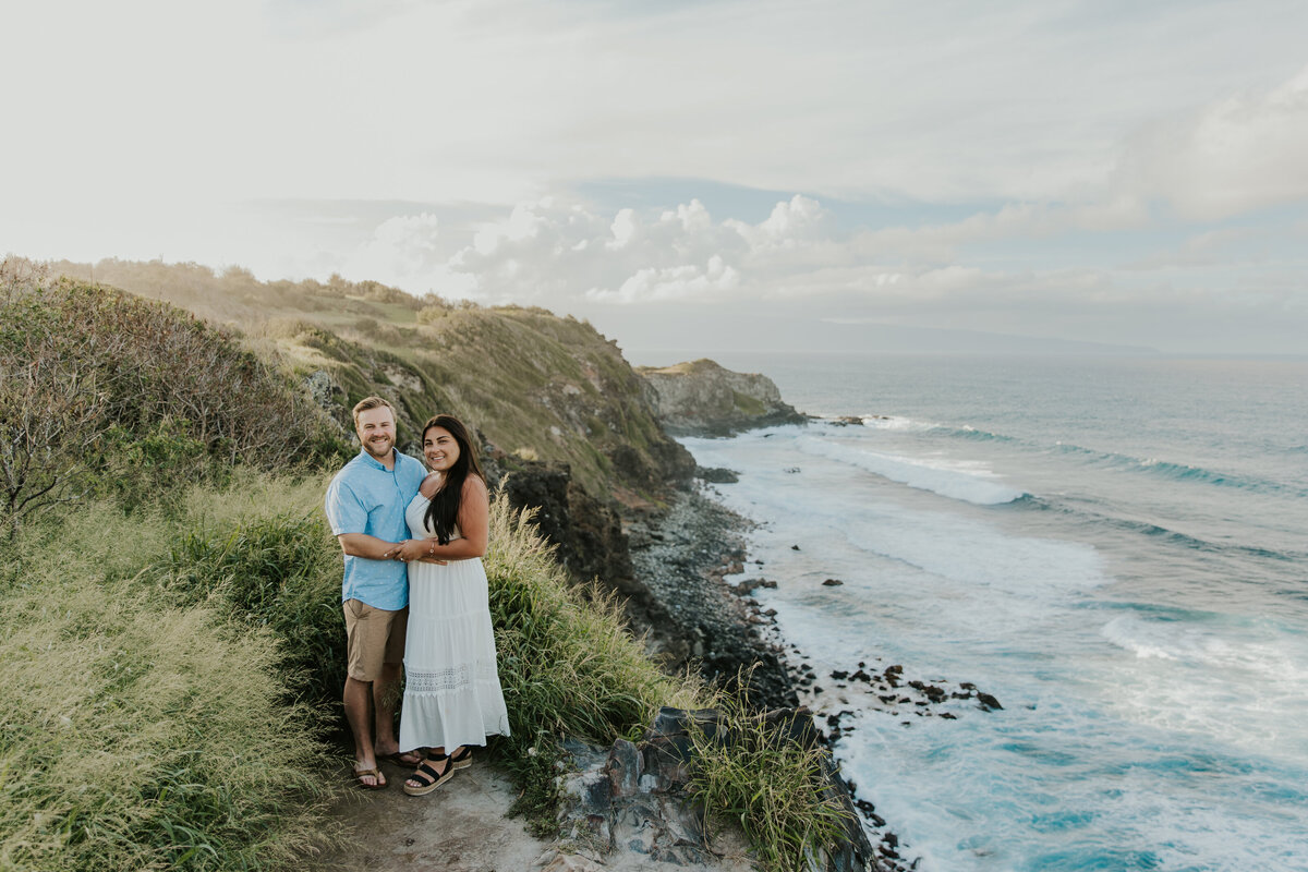 Hawaii Engagement Photographer captures couple laughing on cliff together