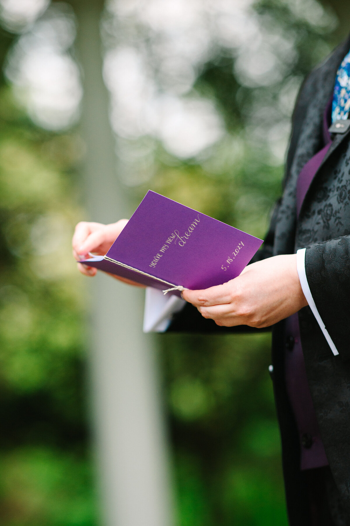 Close up of purple wedding vow book