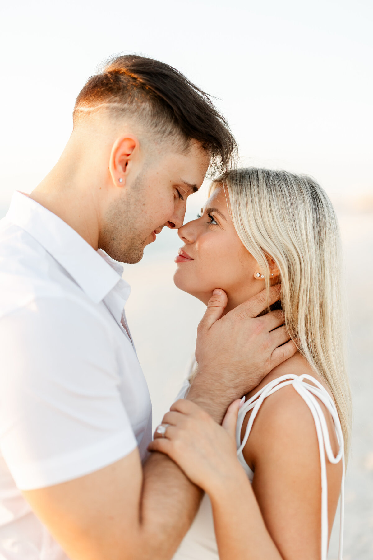 couple embracing and touching noses by wedding photographer naples fl