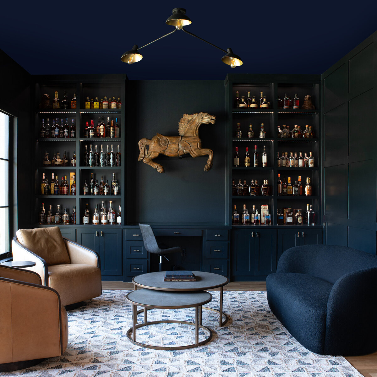 Seating area of a newly constructed Dallas home with a bronze horse sculture adorning the wall