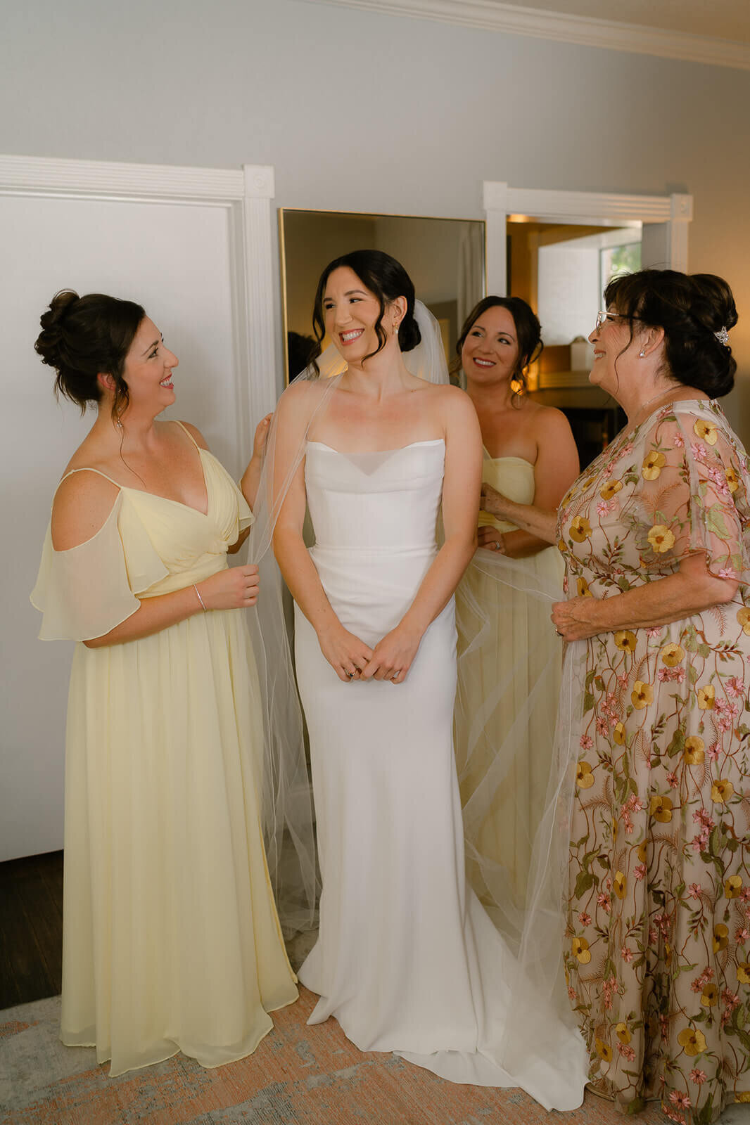 bride and her mom and sisters in the bridal suite