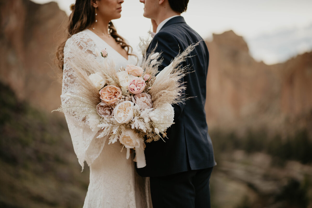 Close up photo of bride and groom and bouquet at Smith Rock