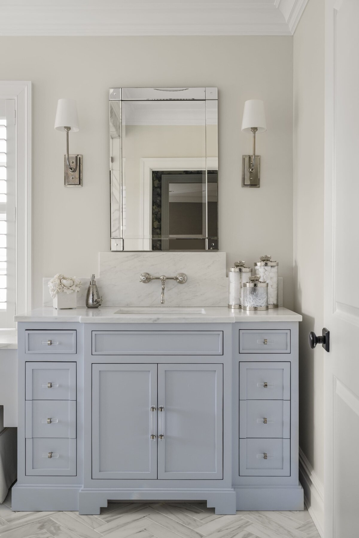 candra lynn interiors ocean port project bathroom sink with blue cabinets and framless mirror