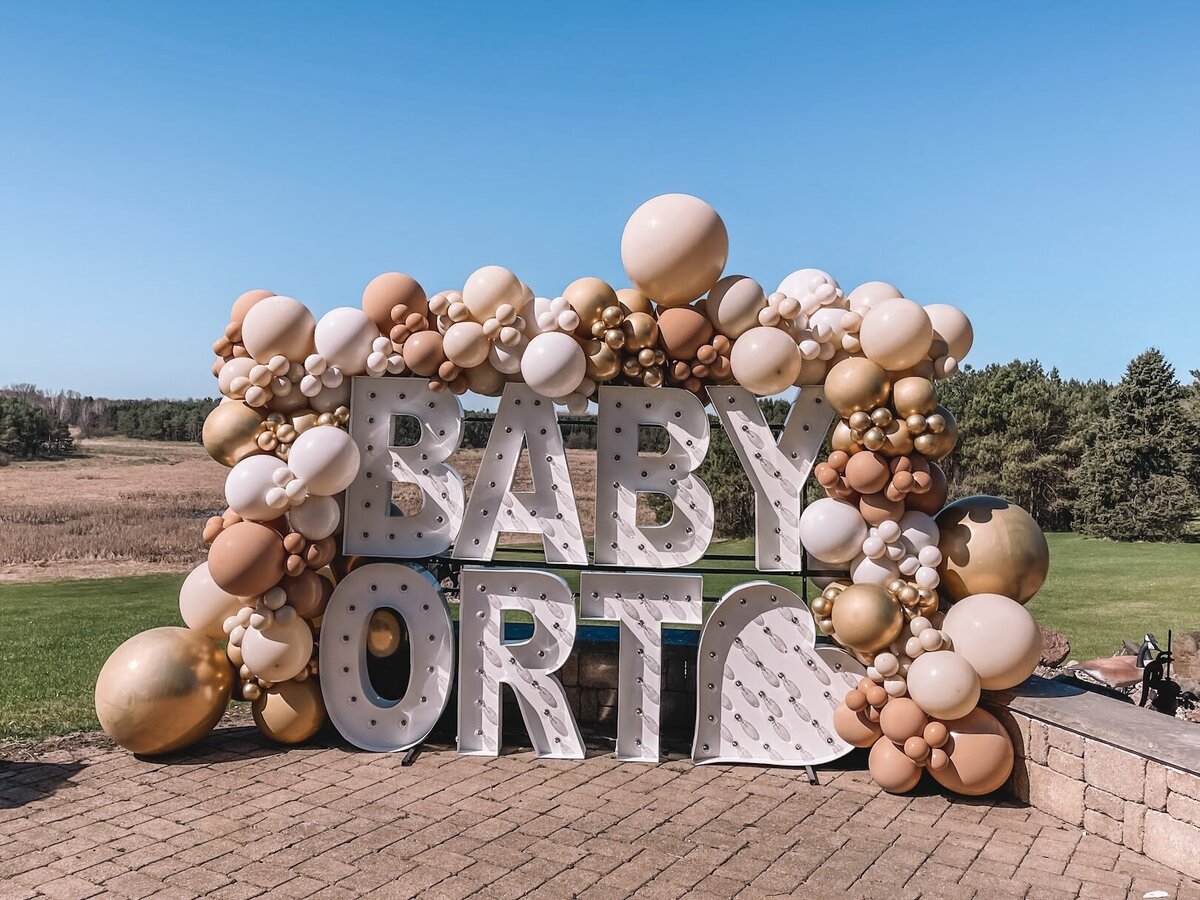 Outdoor giant marquee letters with neutral balloons all around