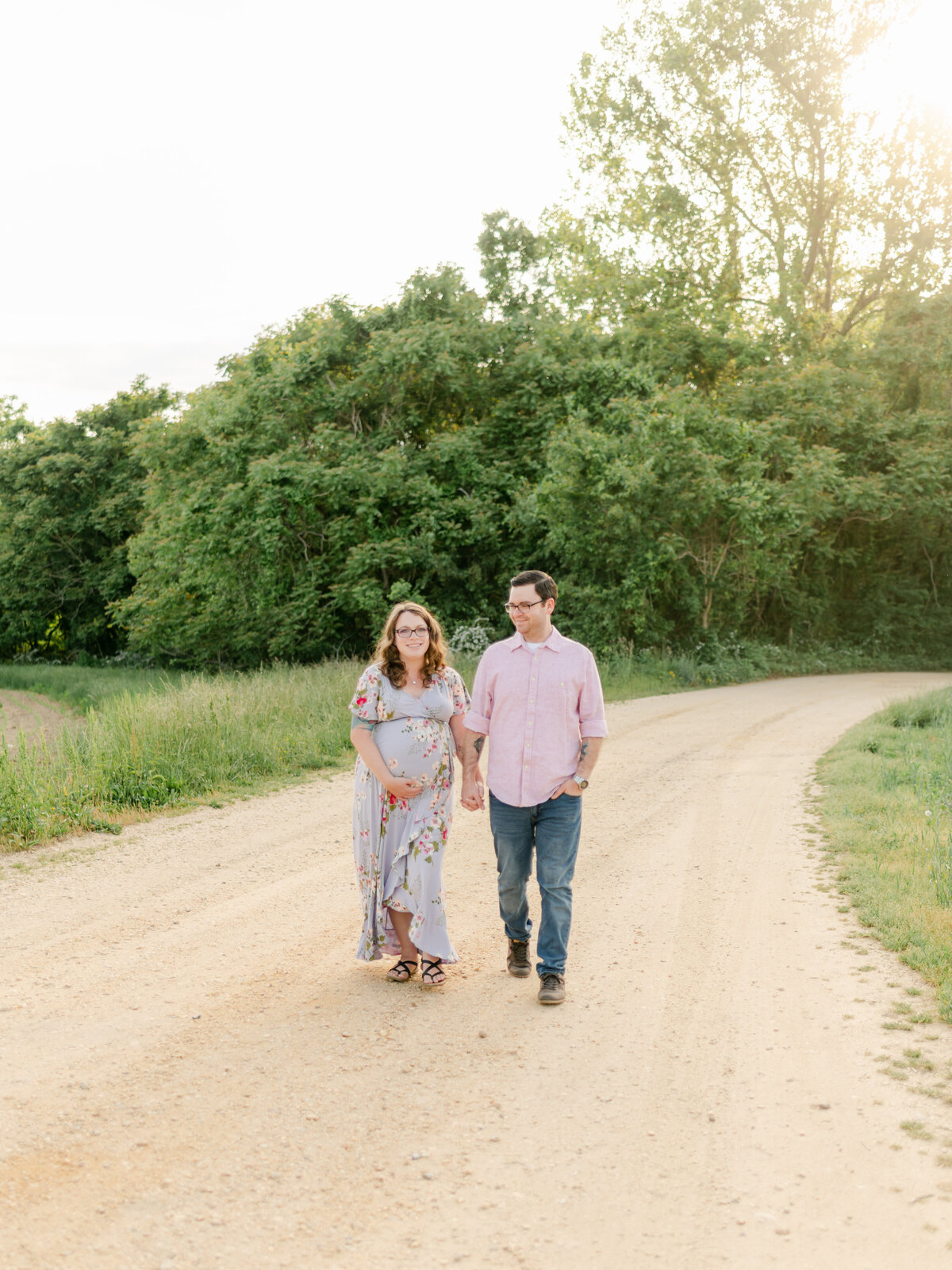 Mom and Dad holding hands on dirt road.