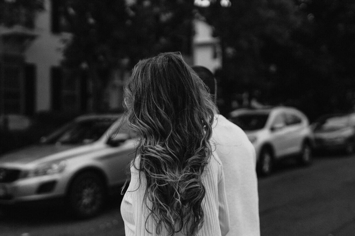 Woman with long hair walking along in a neighbood in Finger Lakes NY