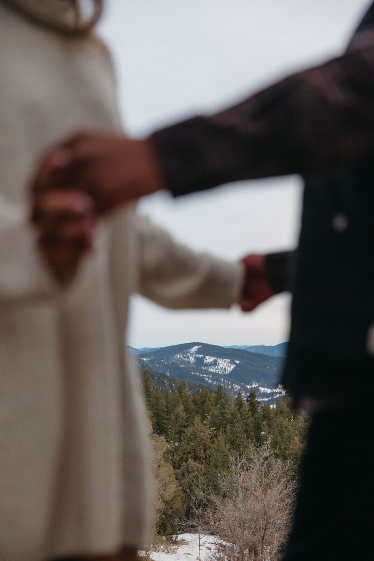 Couple holding hands in the mountains for orlando engagement photography session with Marissa Nicole