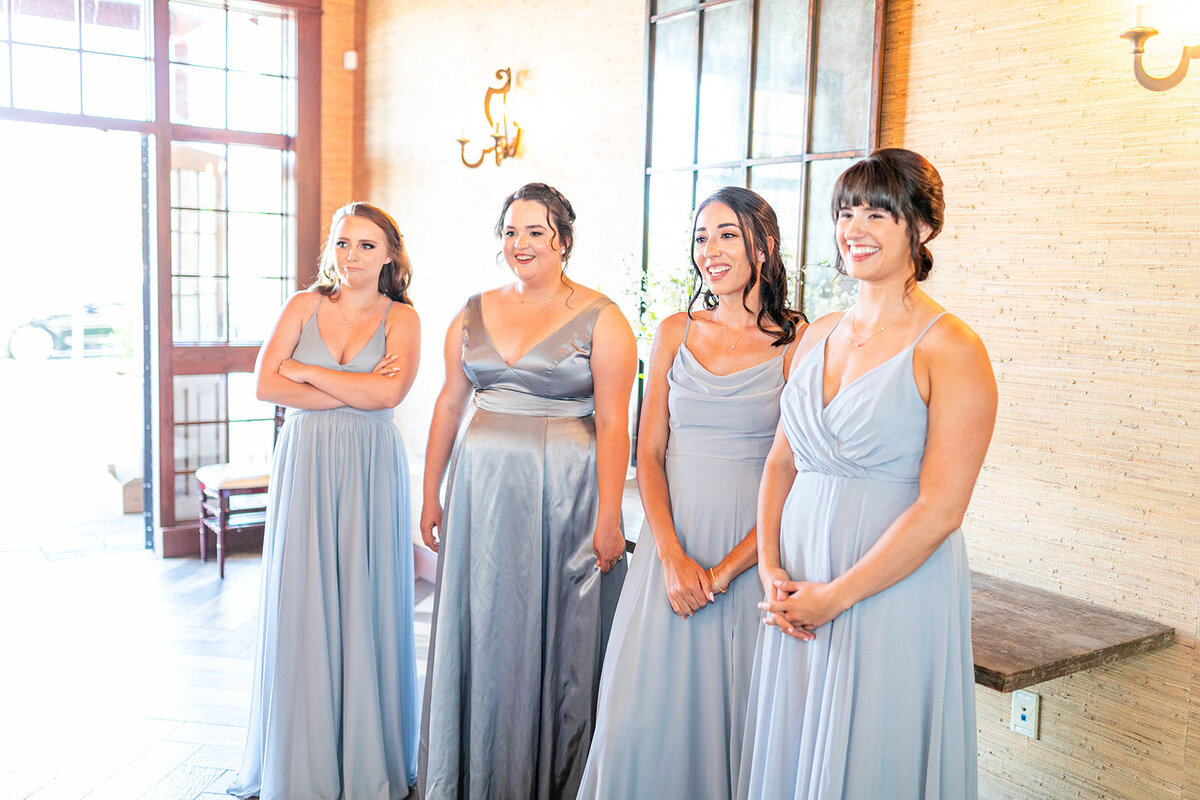 Bridesmaids doing first look with bride