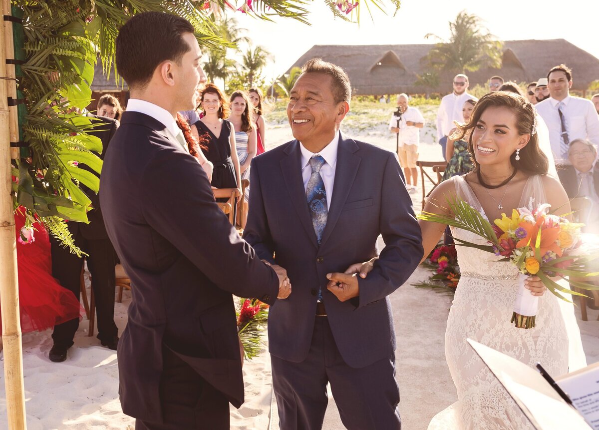 Father handing over bride at wedding in Cancun