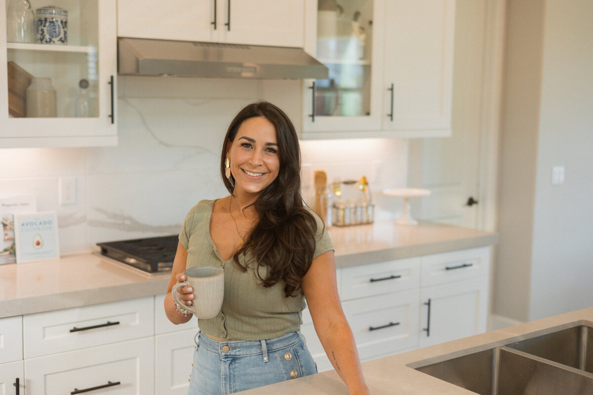 Monica Imani smiling in her kitchen