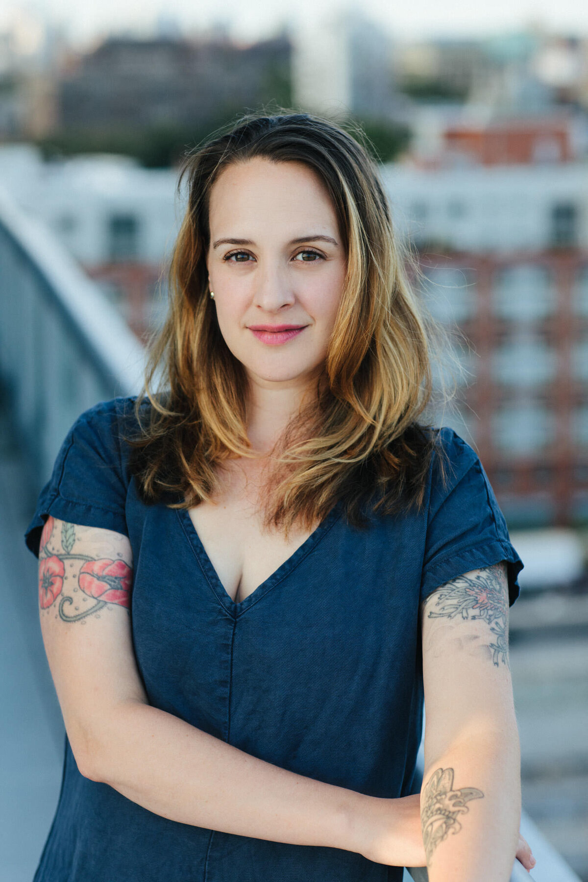 author portrait of emily gould standing on a rooftop