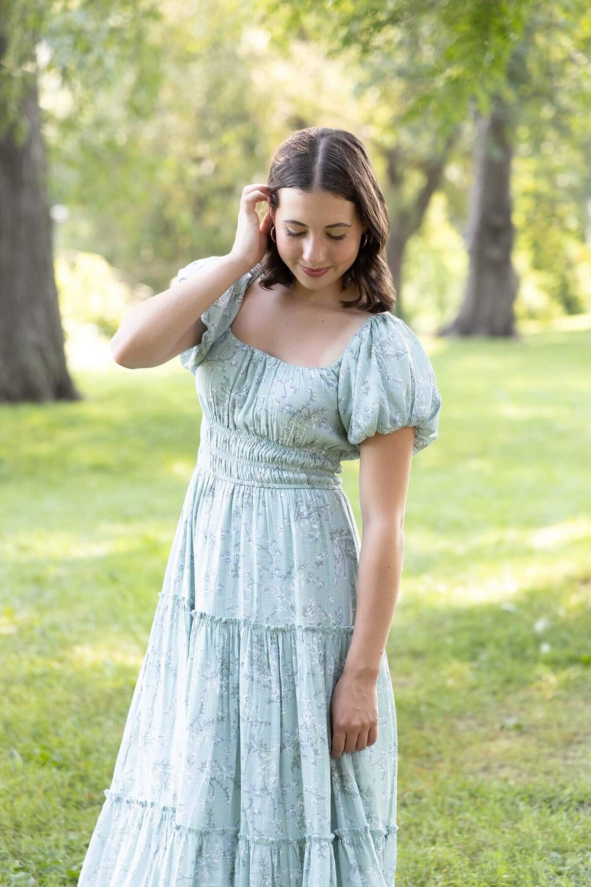 senior-girl-looking-down-in-park-with-dress