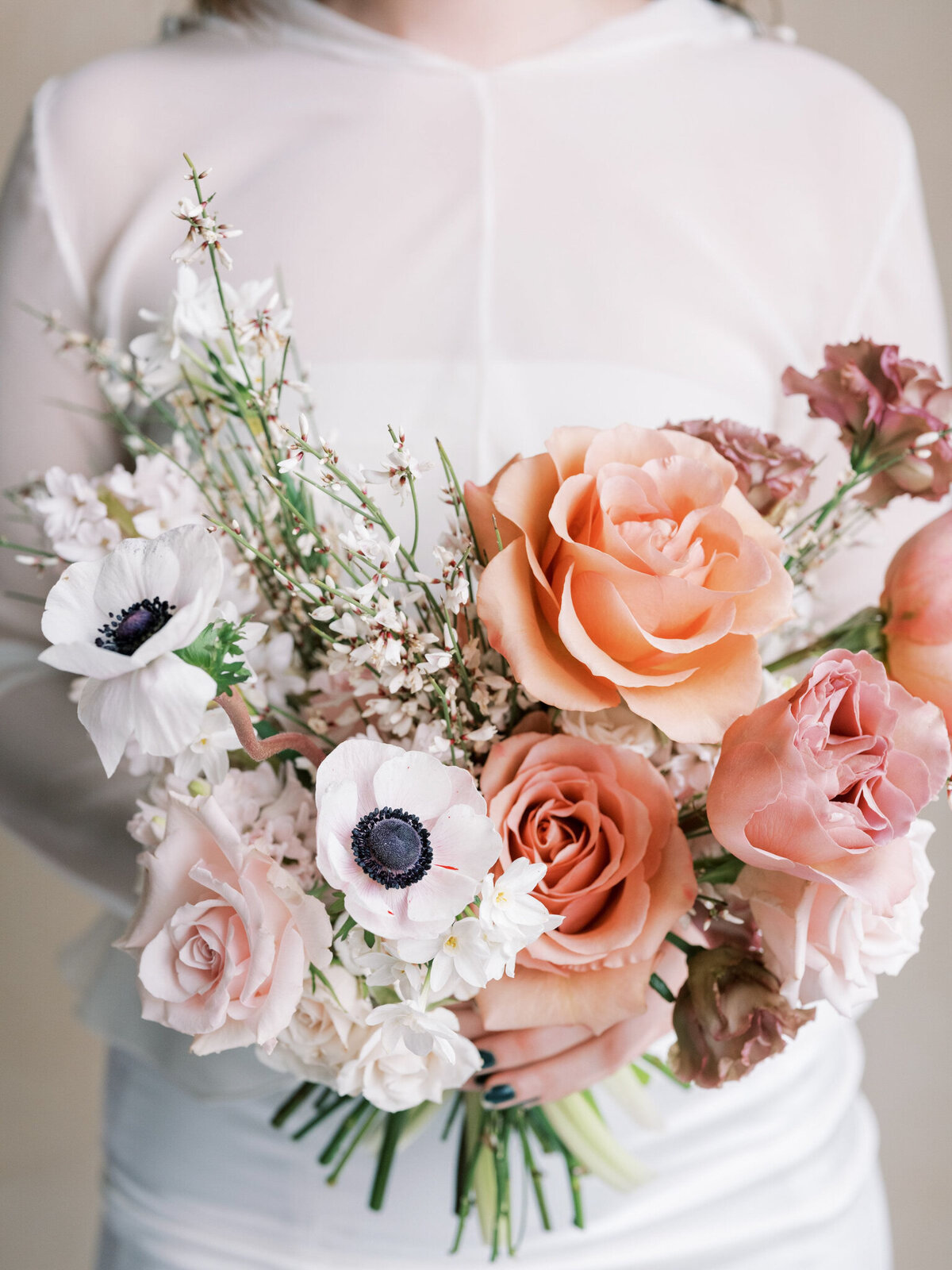 Bridal bouquet of peach, and pink roses by Valley Bloom Co, bright and airy wedding florals based in Kelowna, BC. Featured on the Brontë Bride Vendor Guide.