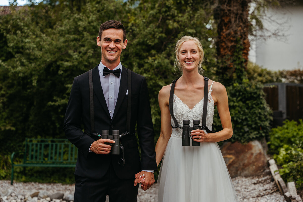 Bride and groom standing together in hotel garden
