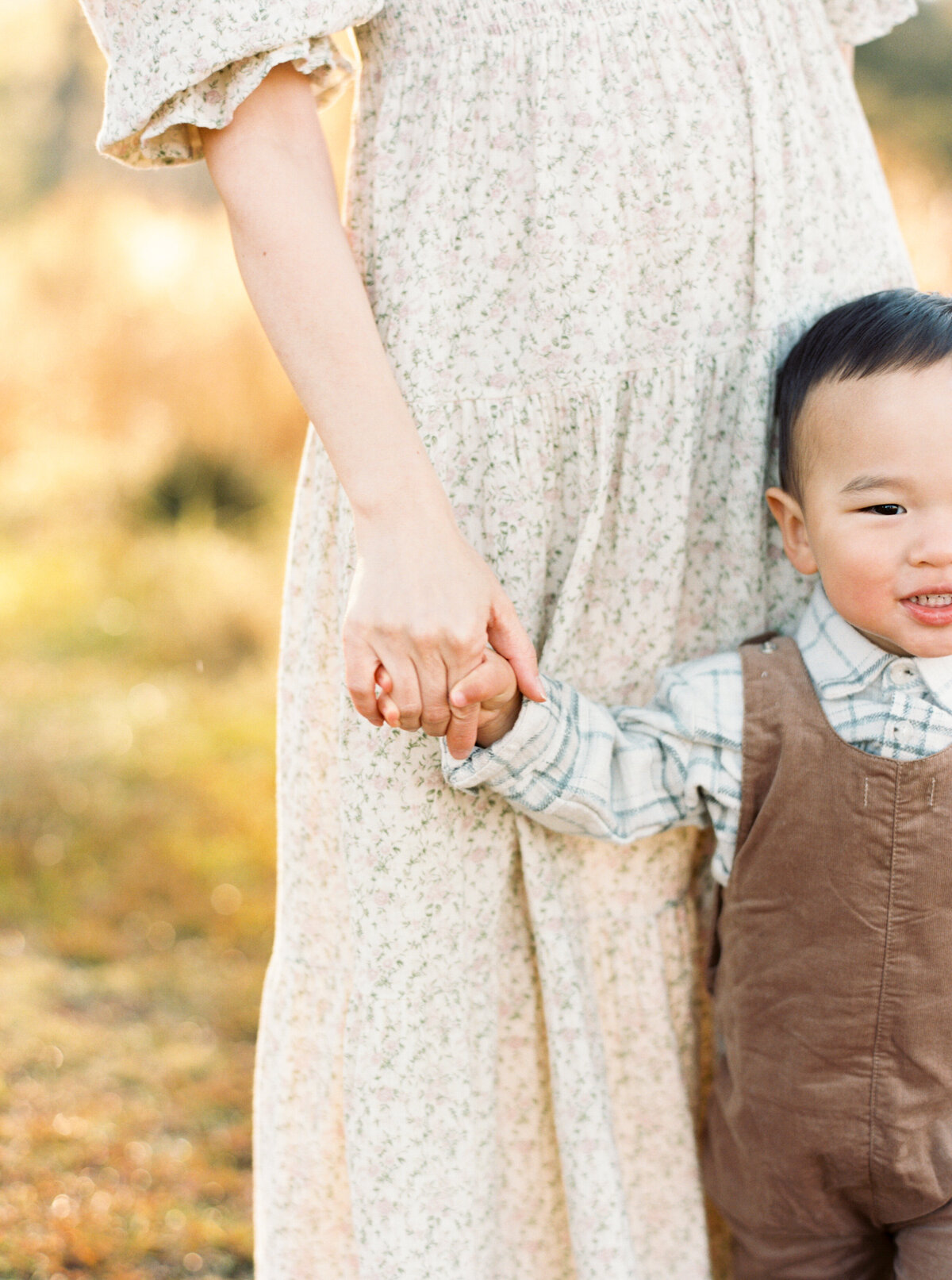 Close up of mom and son's hands. Image by Raleigh maternity photographer A.J. Dunlap Photography.