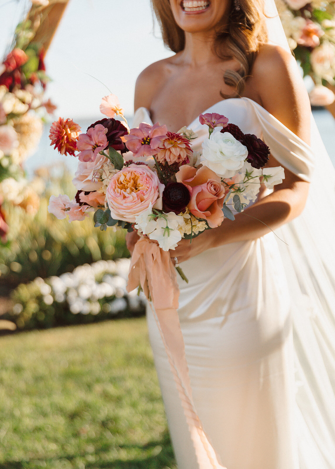 Bride's bouquet and dress details for a wedding at The Lake House on Canandaigua