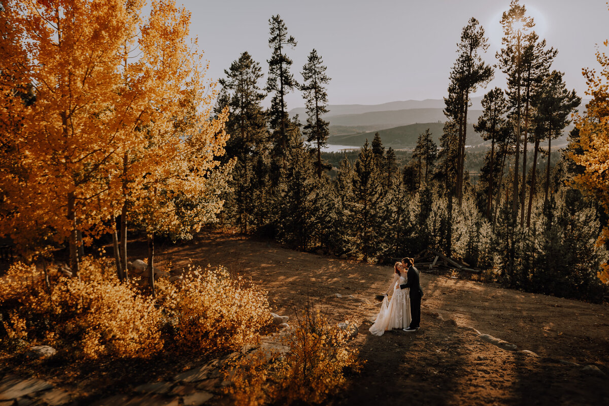 FALL COLORED LEAVES SURROUNDING JUST MARRIED COUPLE IN COLORADO