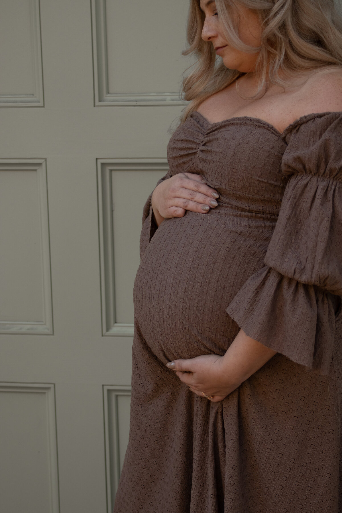 close up of expecting mom caressing her belly