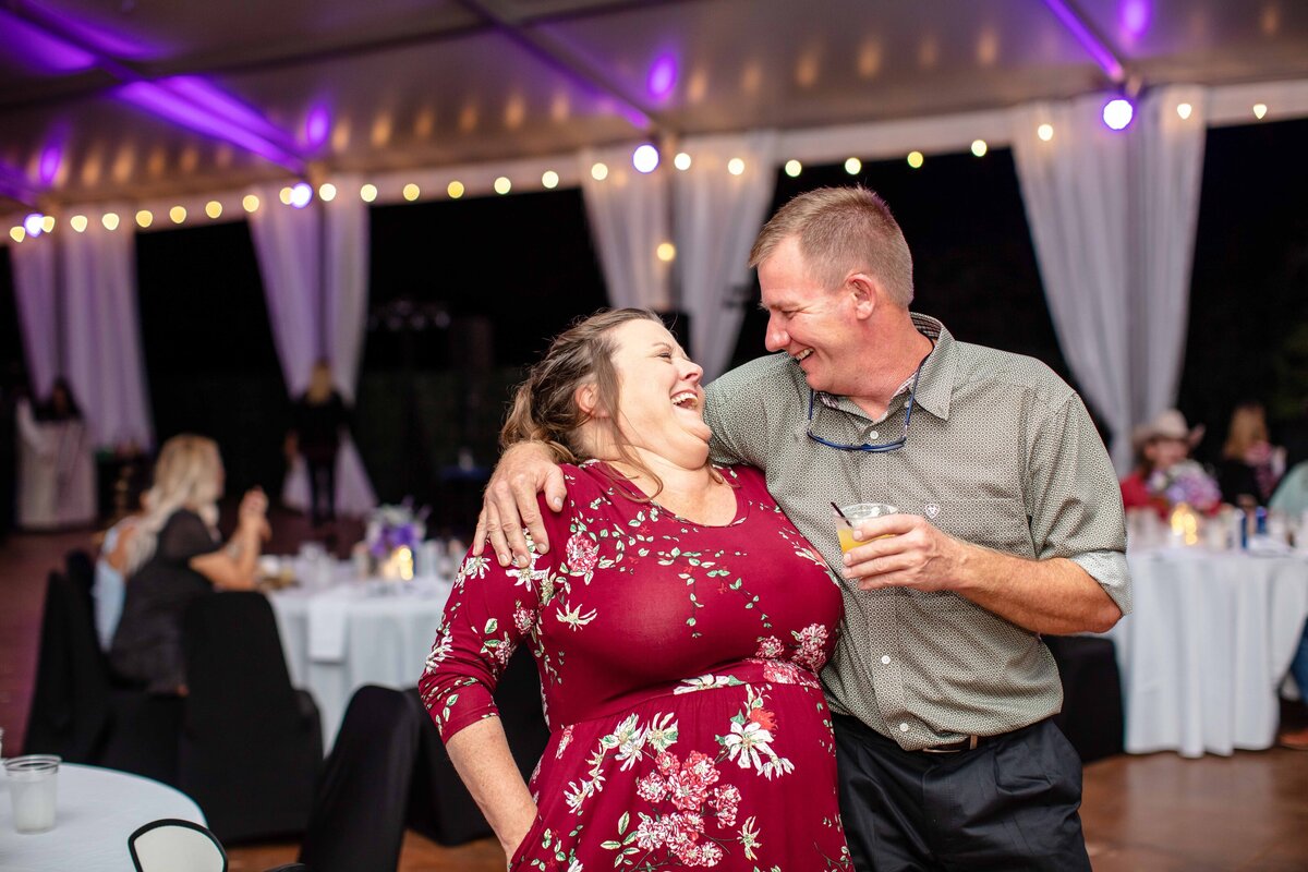 wedding guests dance and hold drinks at New Braunfels wedding