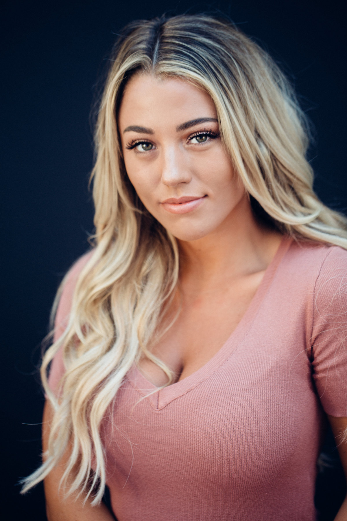 Headshot Photograph Of Young Woman In Pink V-Neck Shirt Los Angeles