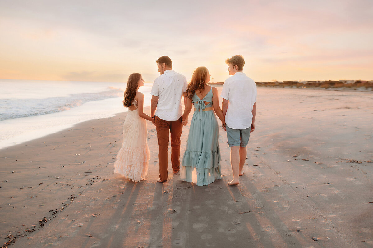 Family walks along the beach together for Family Photos in Isle of Palms.