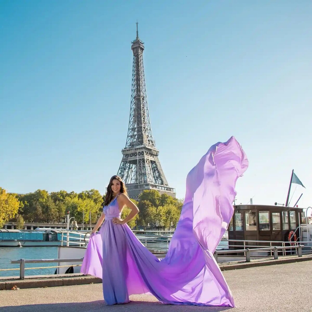 women having a portrait photoshoot in paris wearing a purple flying dress