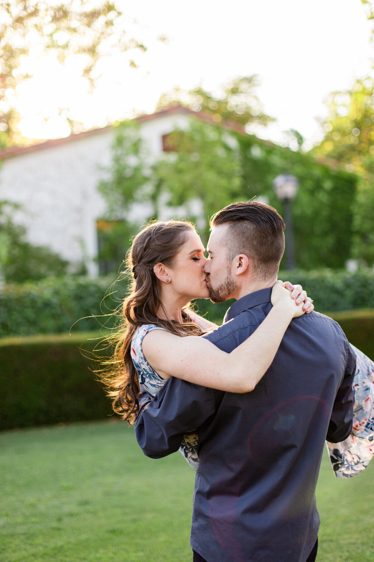 boy kisses girl and spins her in his arms, photo by Love is Magic Photo