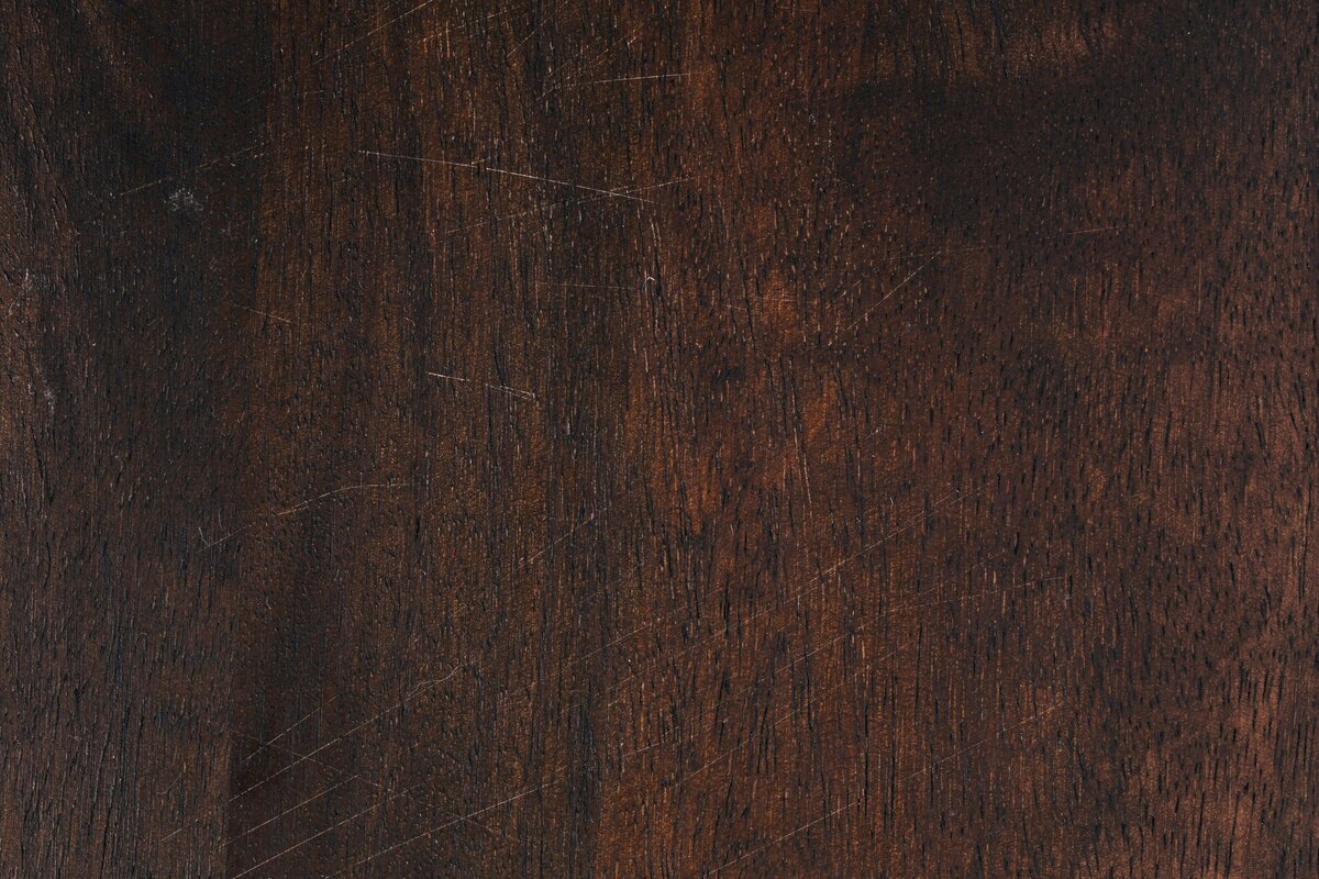 Distressed dark wood table texture with a ew scratches
