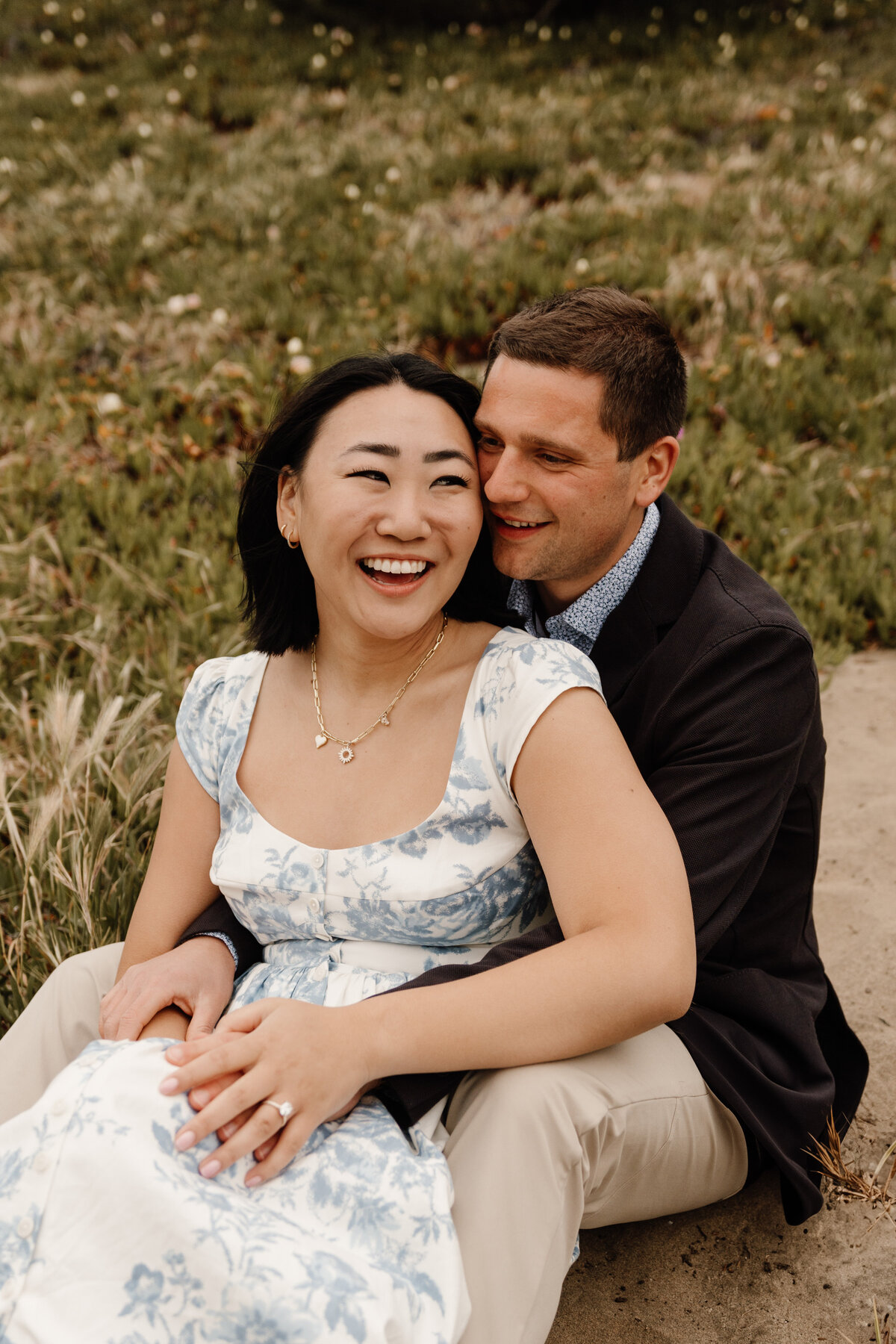 couple sitting on beach in san francisco
