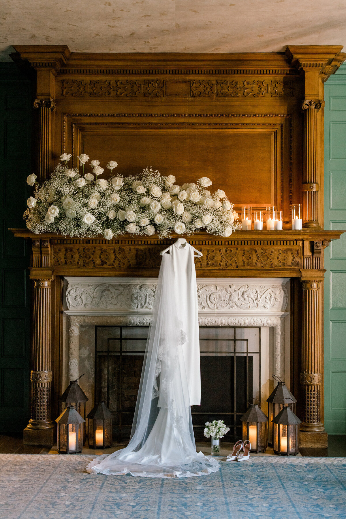 rosa clara wedding dress hanging in pendry natirar fireplace room