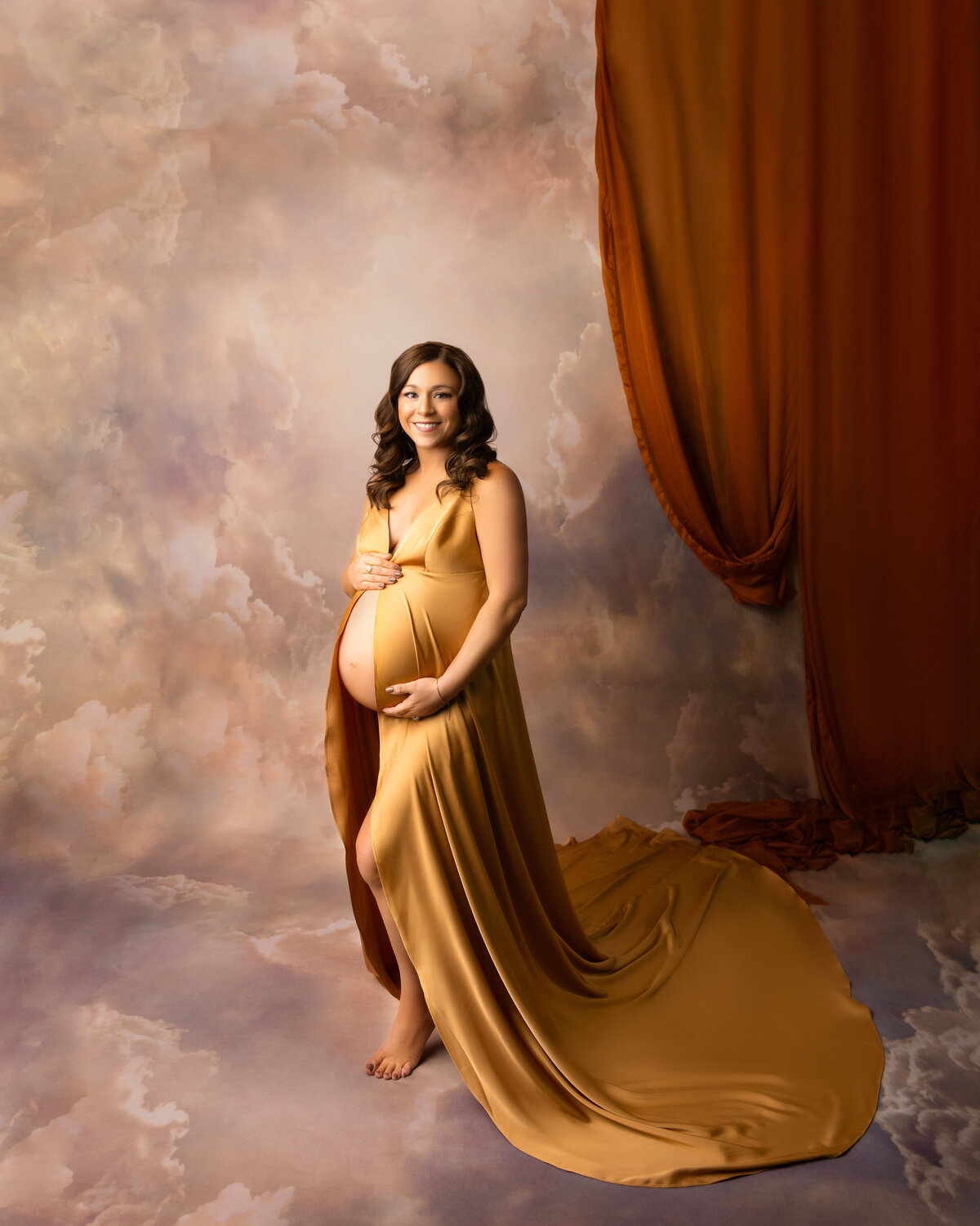 studio new orleans woman pregnant gold dress clouds smile exposed belly