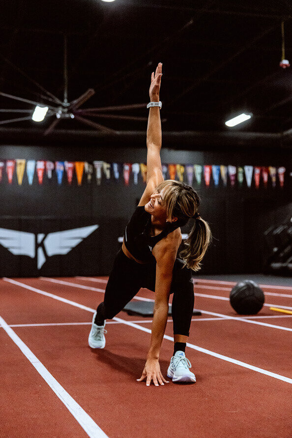 Girl stretches as part of her branding photos for a magazine.